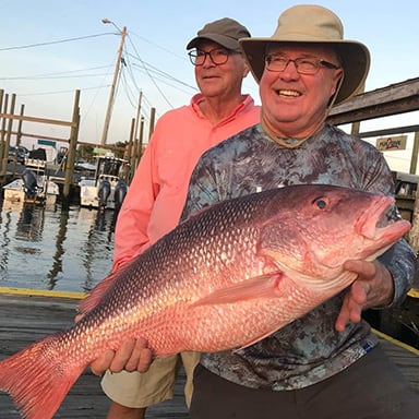 man who caught a redfish on a fishing charter