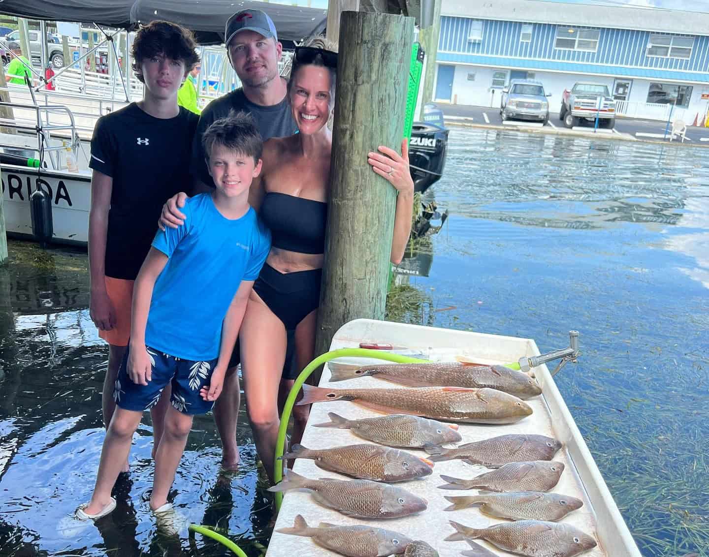 Family showing off their catch from a day out on a fishing charter in Crystal River, FL.