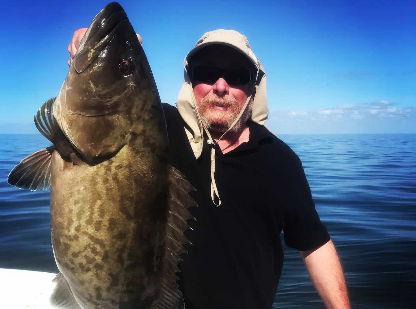 Man holding up a gag grouper he caught while on a fishing charter with Salt River Outfitters in Crystal River, FL.