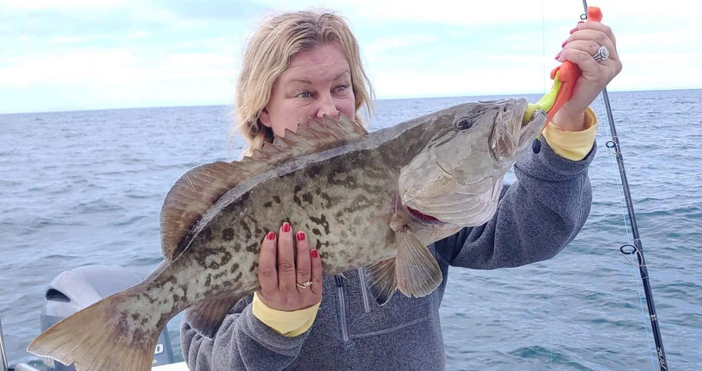 Woman holding up a gag grouper she caught while on a fishing charter with Salt River Outfitters in Crystal River, FL.