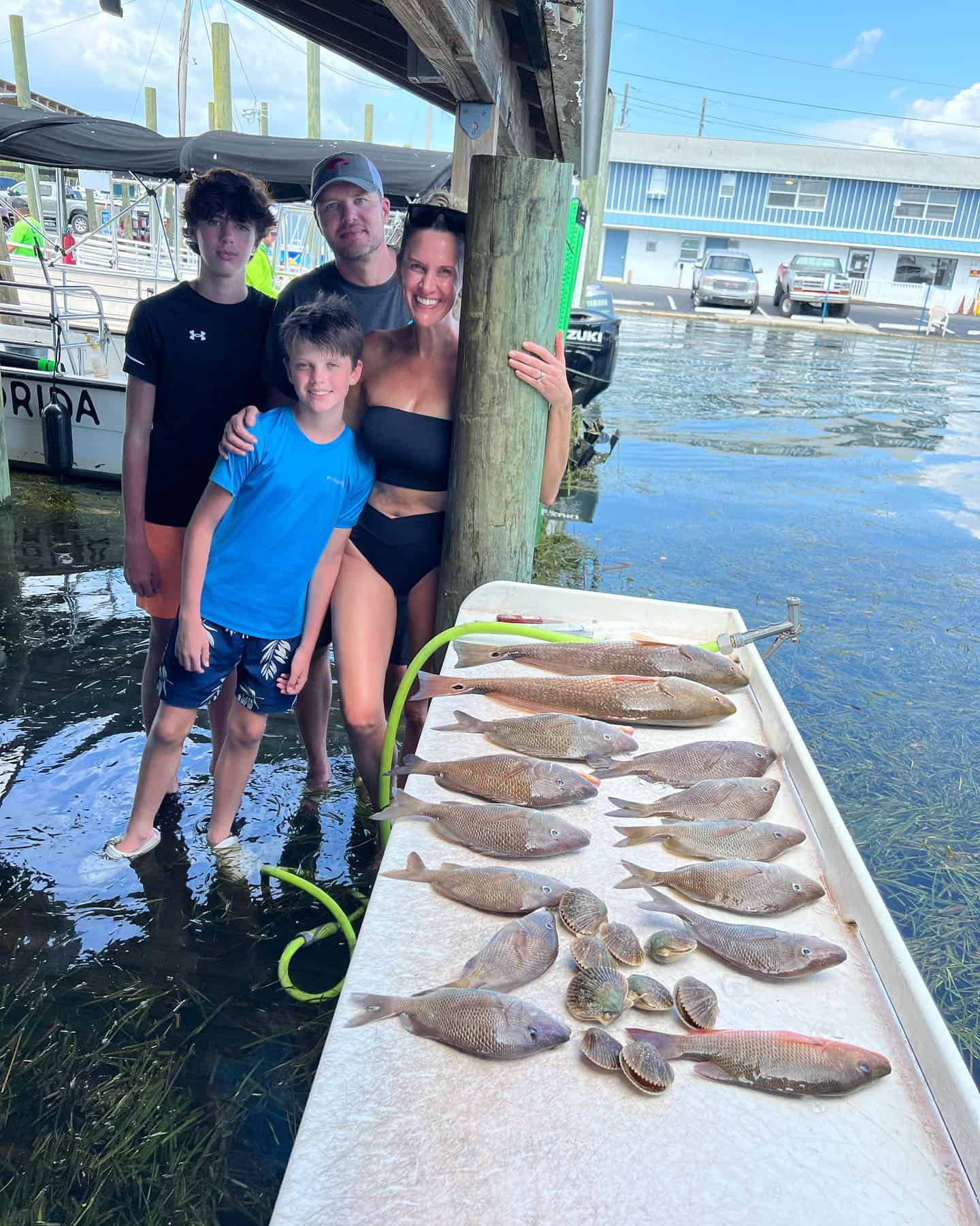 Family standing next to a table with fish laid out.